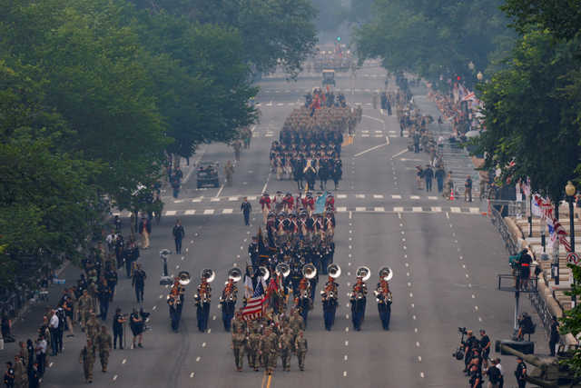 <p>Above, soldiers and an army band march during the parade.</p>